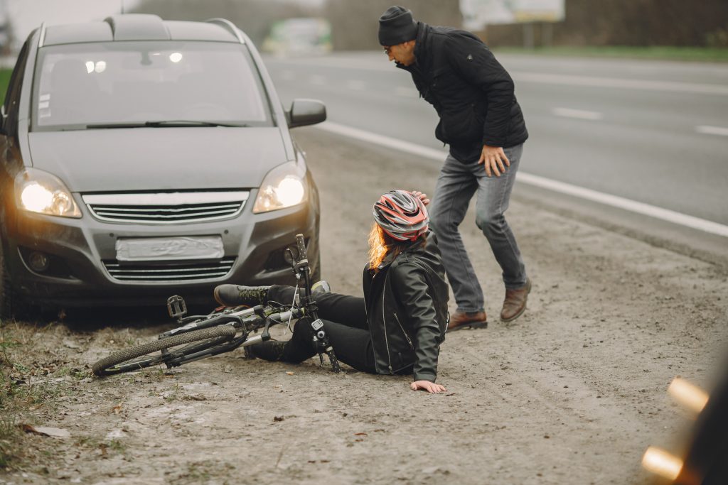 The woman crashed into the car. Girl in a helmet.
